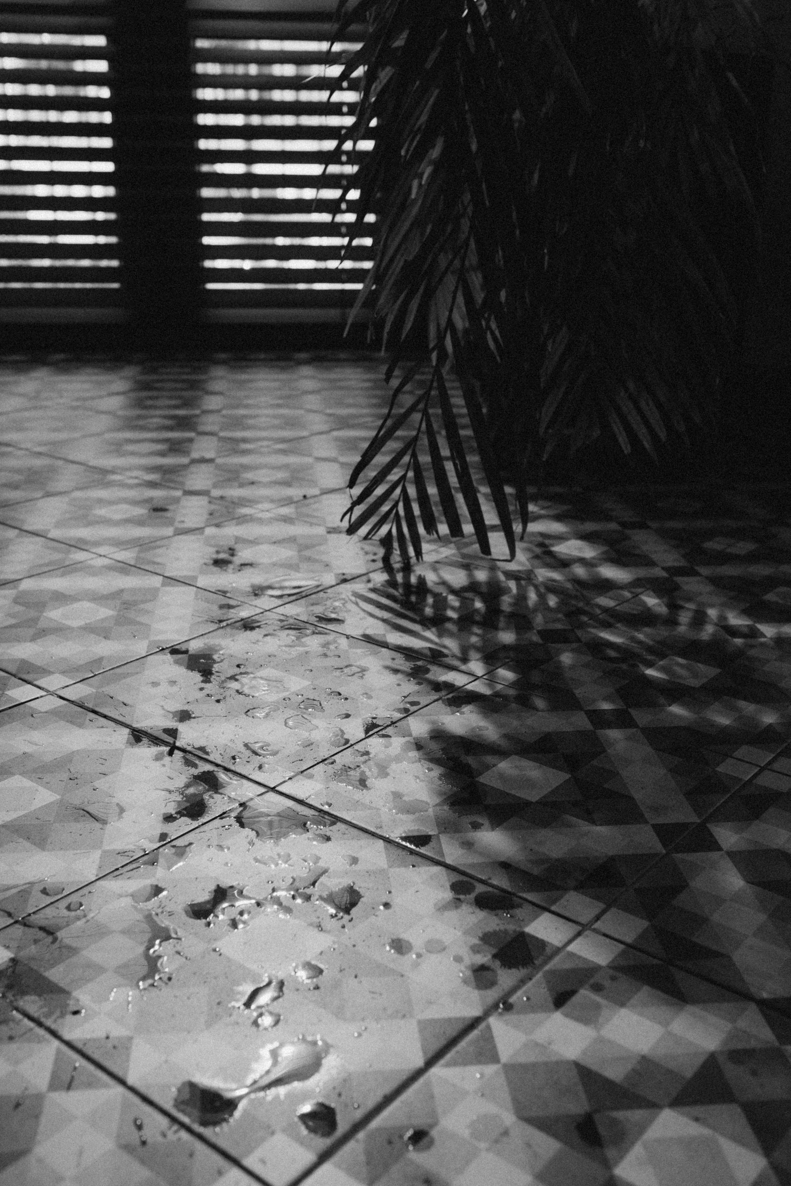 Water spread across a tiled indoor floor.